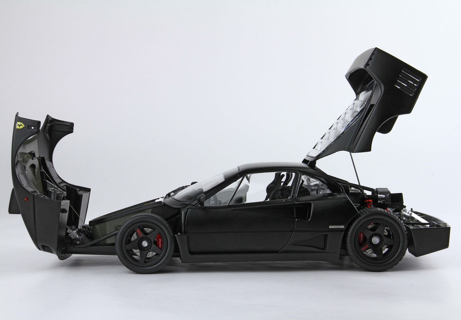 Black Ferrari F40 sports car model with open front and rear hoods showcasing detailed interior and engine, offered on Vroomi