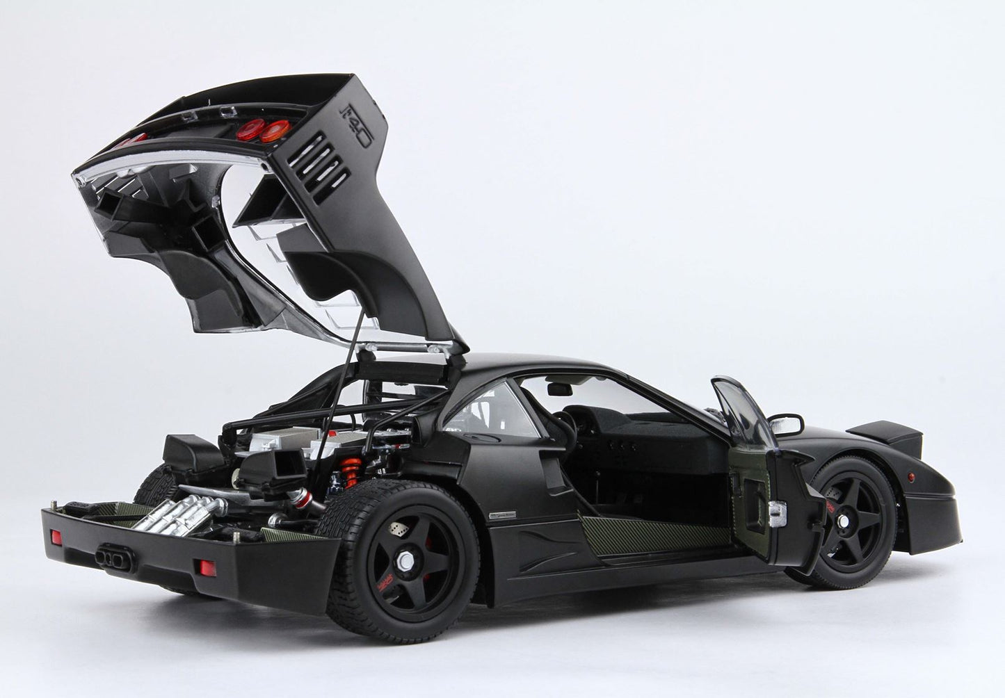 Black sports model car with open rear hood and door showing detailed engine and interior, available on Vroomi