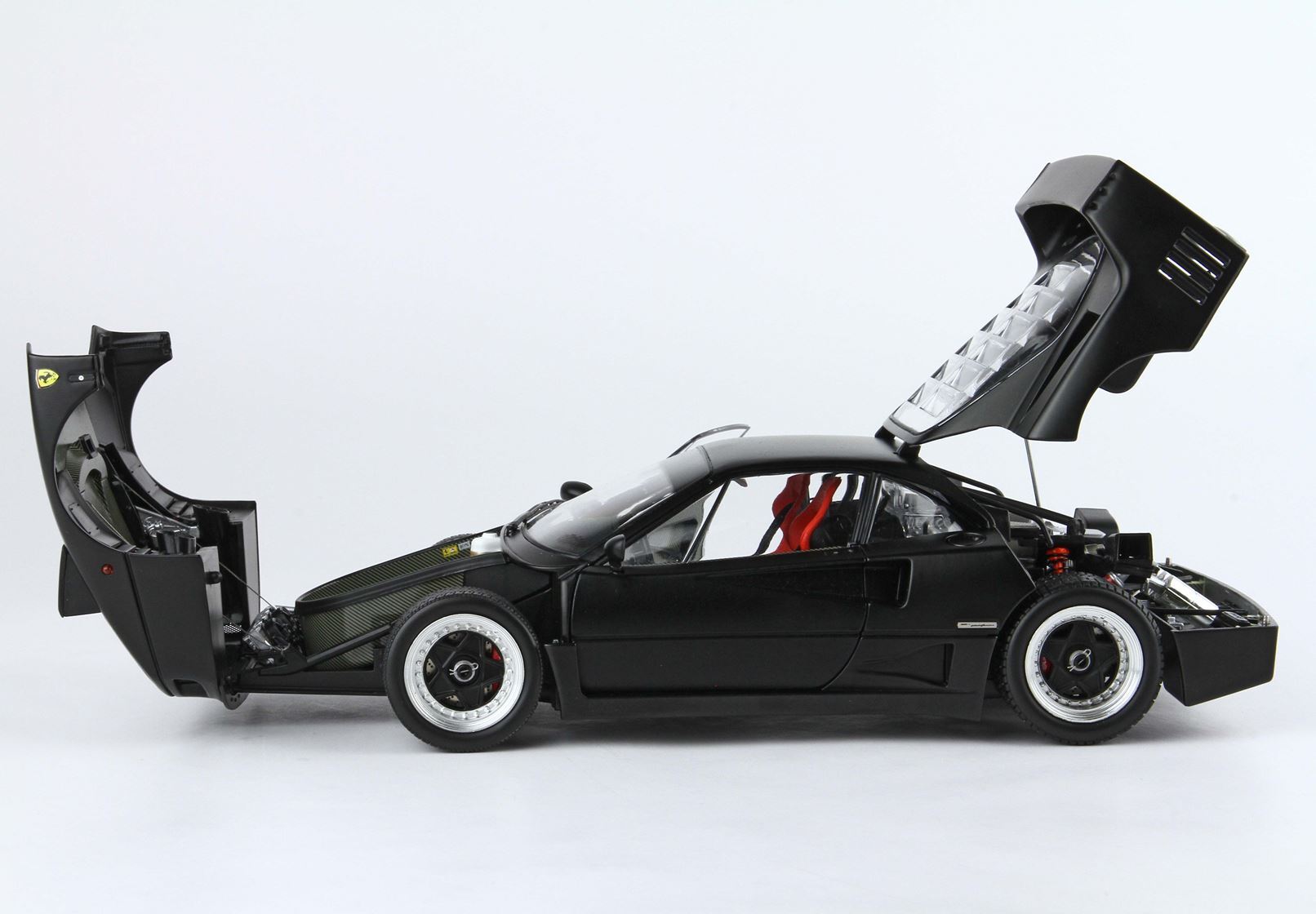 Black Ferrari F40 model car with open front and rear hoods, red interior seats, available on Vroomi