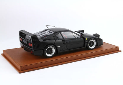 Matte black Ferrari F40 model car on brown leather display base, available on Vroomi