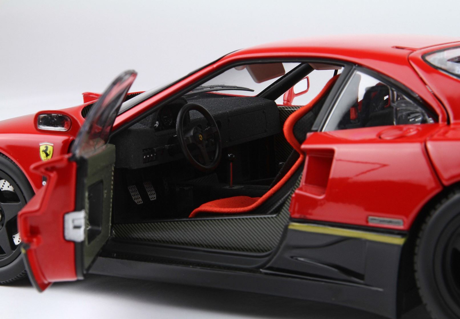 Red Ferrari sports car with open door showing black and red interior details, available on Vroomi platform