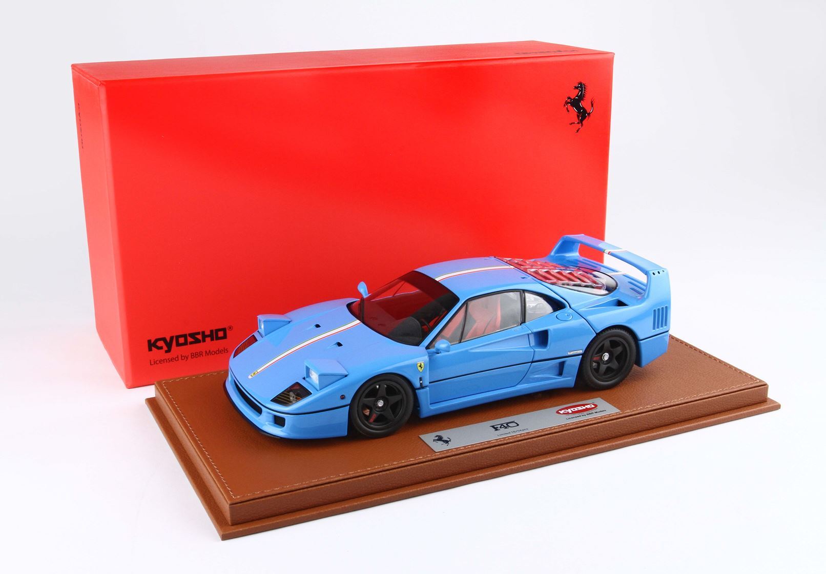 Blue Ferrari F40 model car by Kyosho displayed on leather base with red Ferrari-themed box, available on Vroomi