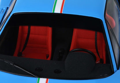 Blue sports car interior with red seats, black steering wheel, and Italian flag stripe, available on Vroomi