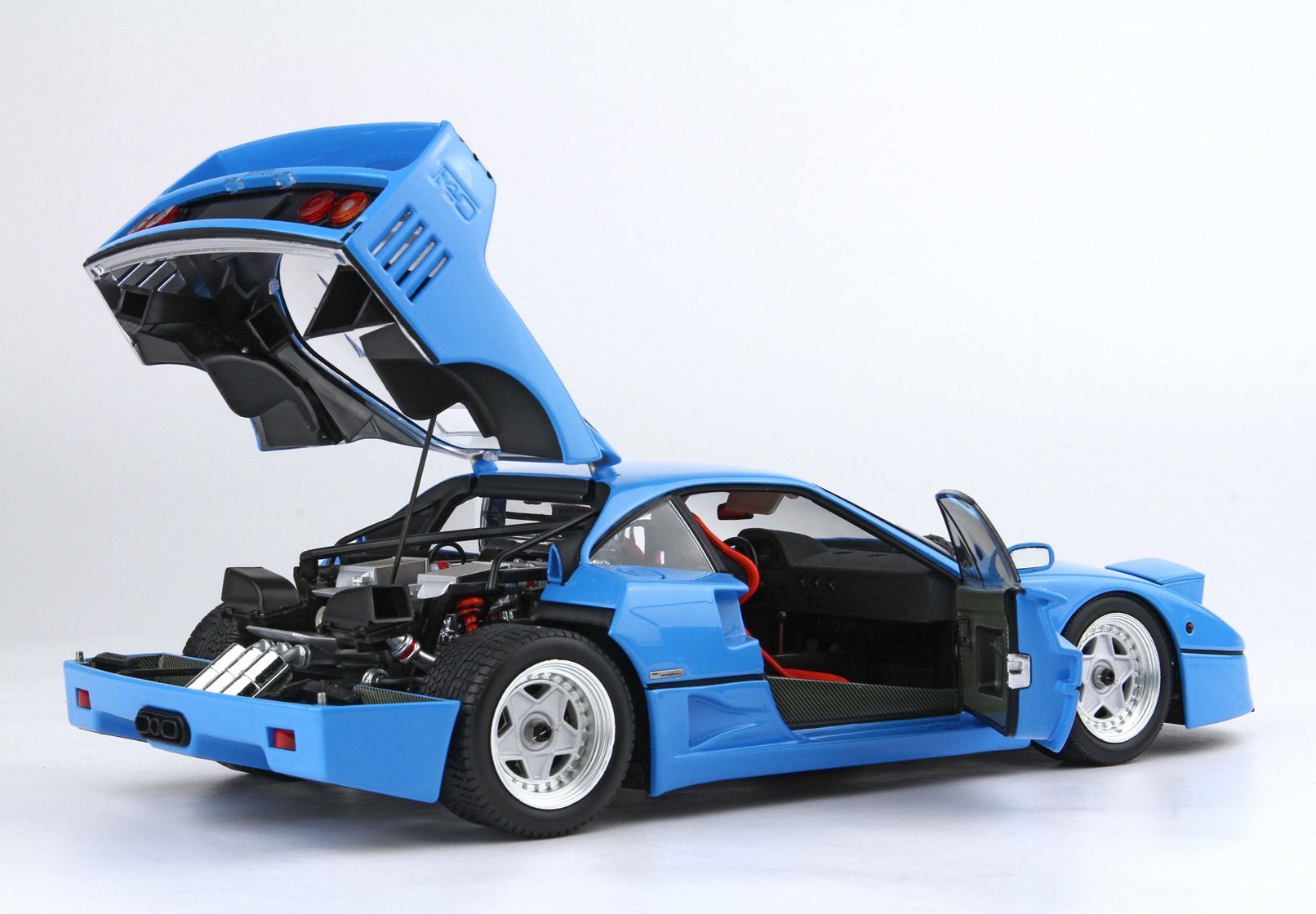 Blue sports car model with open rear engine cover and open driver door, detailed interior and wheels, available on Vroomi
