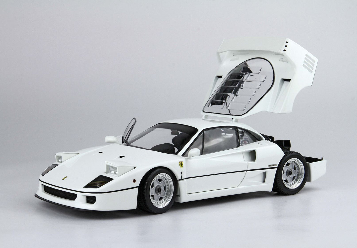 White Ferrari F40 model car with open rear engine cover and driver's side door, available on Vroomi