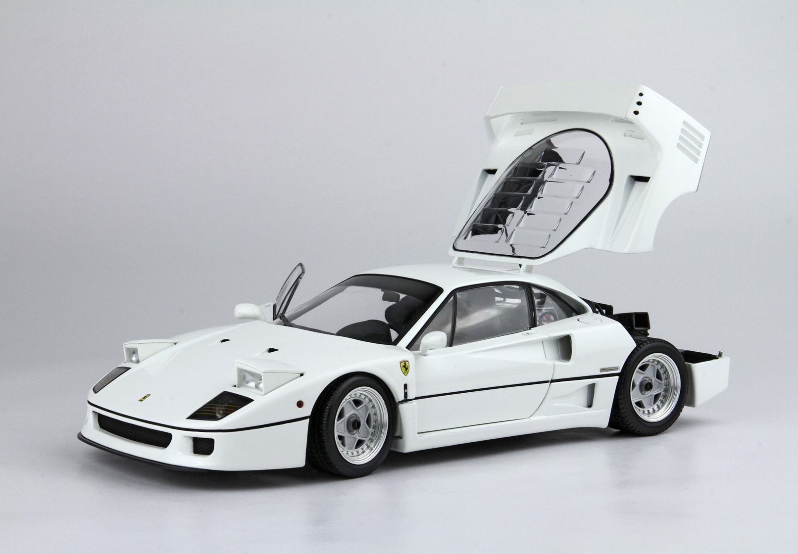 White Ferrari F40 model car with open rear engine cover and driver's side door, available on Vroomi