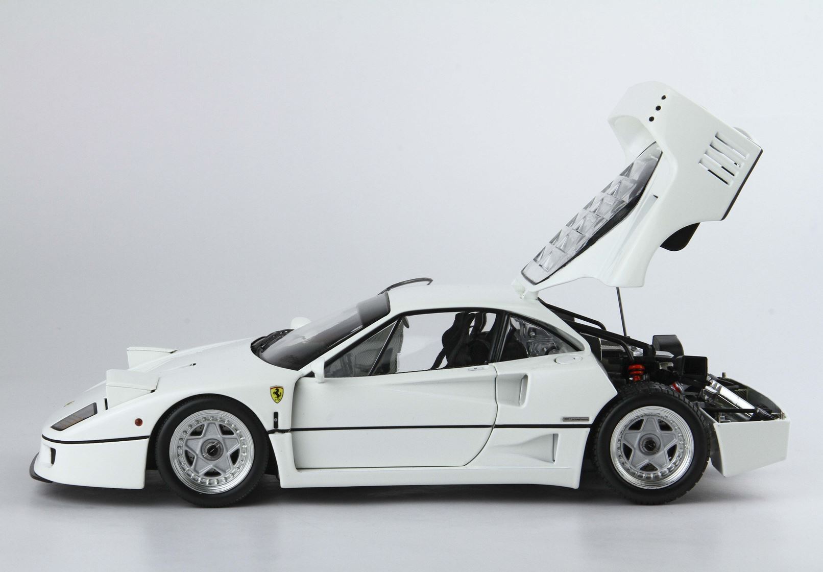 White Ferrari F40 sports car model with rear hood open, detailed engine view, available on Vroomi