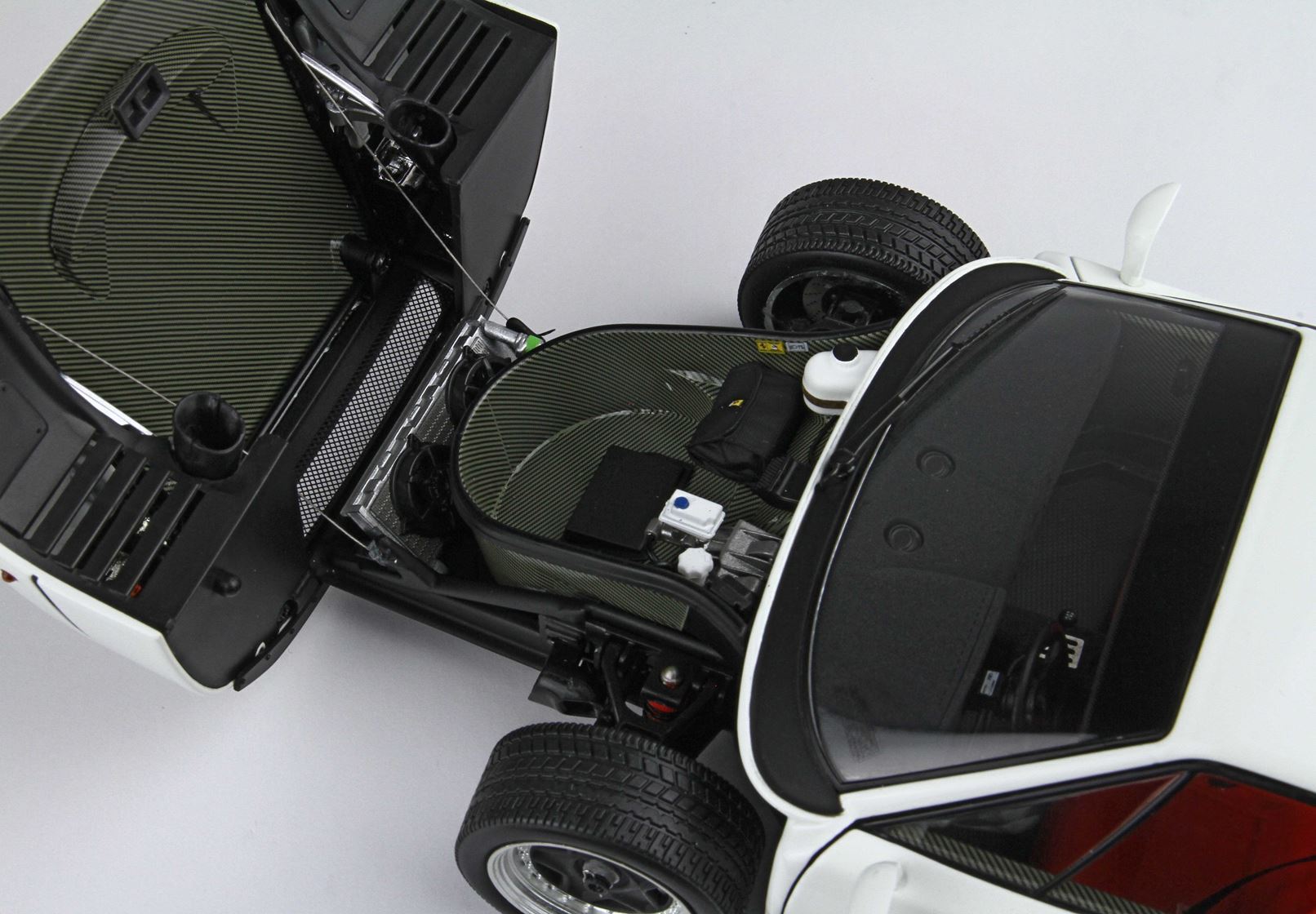 White sports car with front hood open showing detailed engine bay and front wheel, available on Vroomi