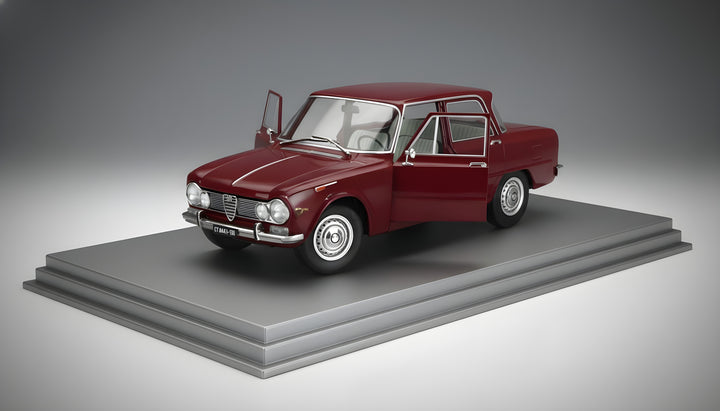 Model of a classic red car on a gray platform with a gray background