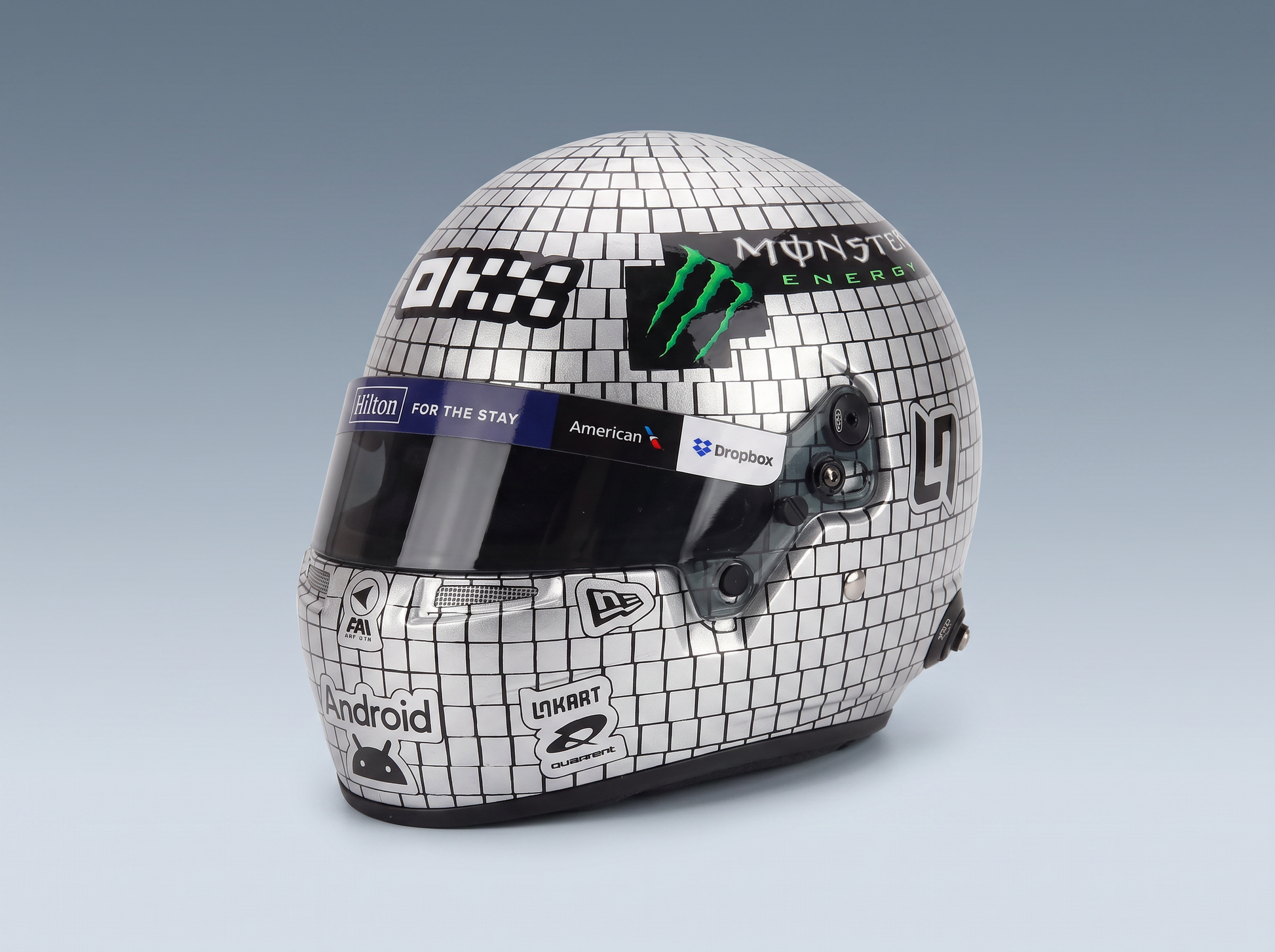 Scale model car helmet with Monster Energy, Android, and Dropbox logos, featured at Vroomi
