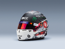 Scale model car racing helmet with Monster Energy, DP World, and Liberty Media logos, featured by Vroomi