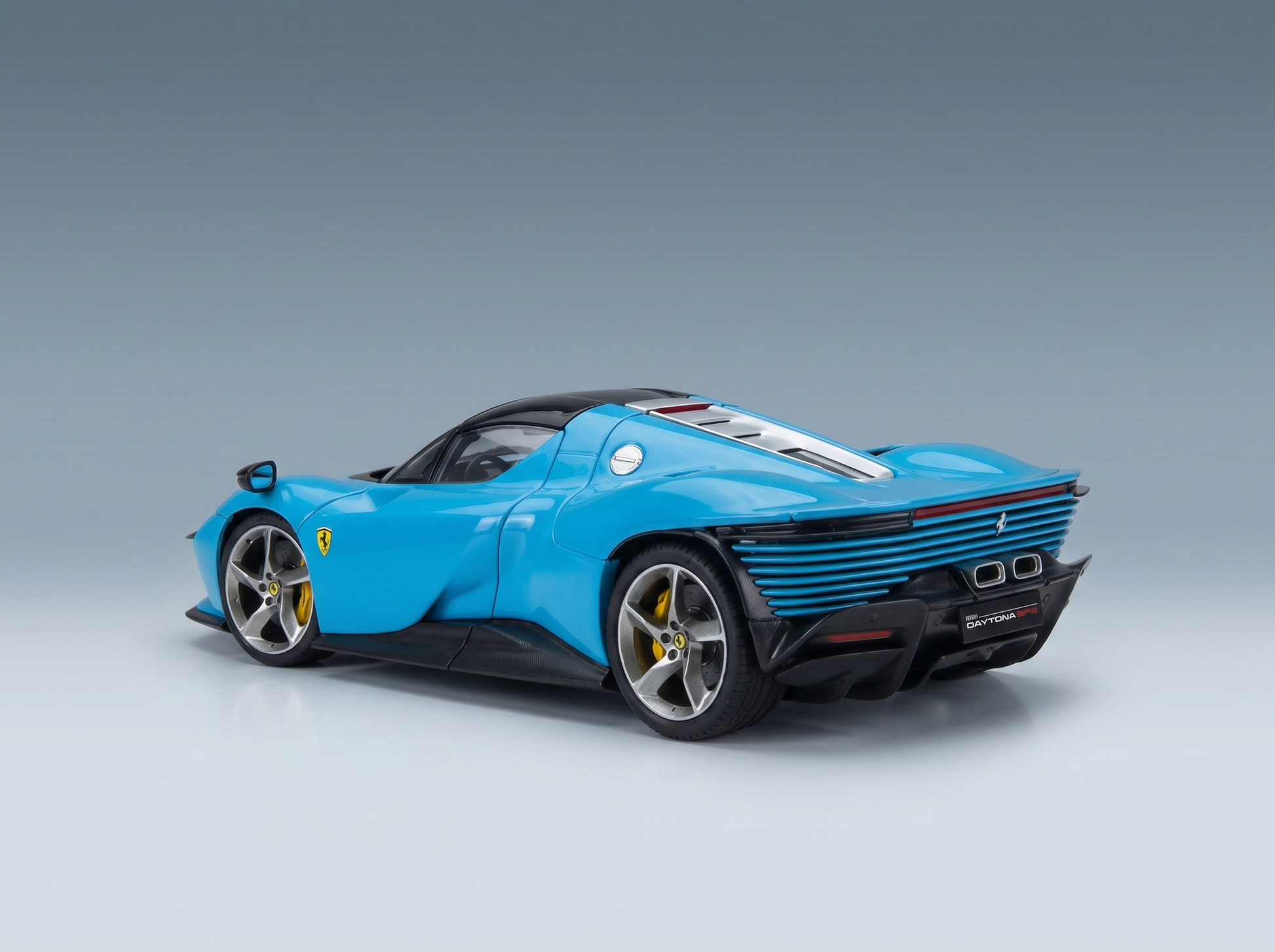 Blue Ferrari Daytona SP3 scale model car from Vroomi, showcasing sleek design and detailed rear grille.