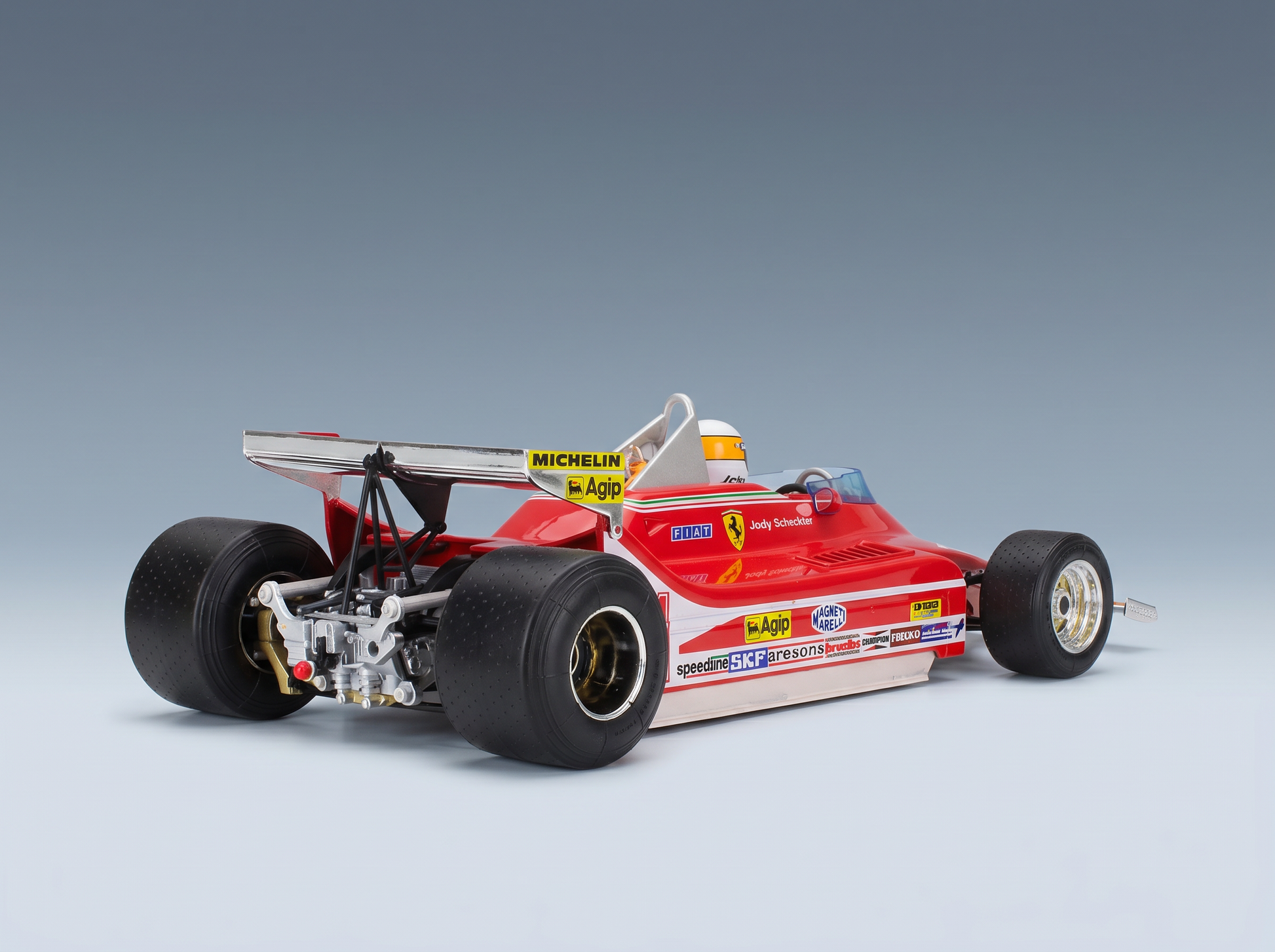 Red Ferrari F1 scale model car with sponsor decals, displayed by Vroomi for collectors