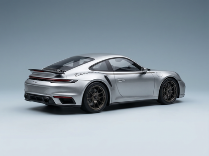 Silver Porsche 911 Turbo S scale model car from Vroomi, showcasing detailed rear spoiler and alloy wheels.