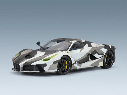 White and gray camo scale model car with yellow accents, showcased by Vroomi for collectors