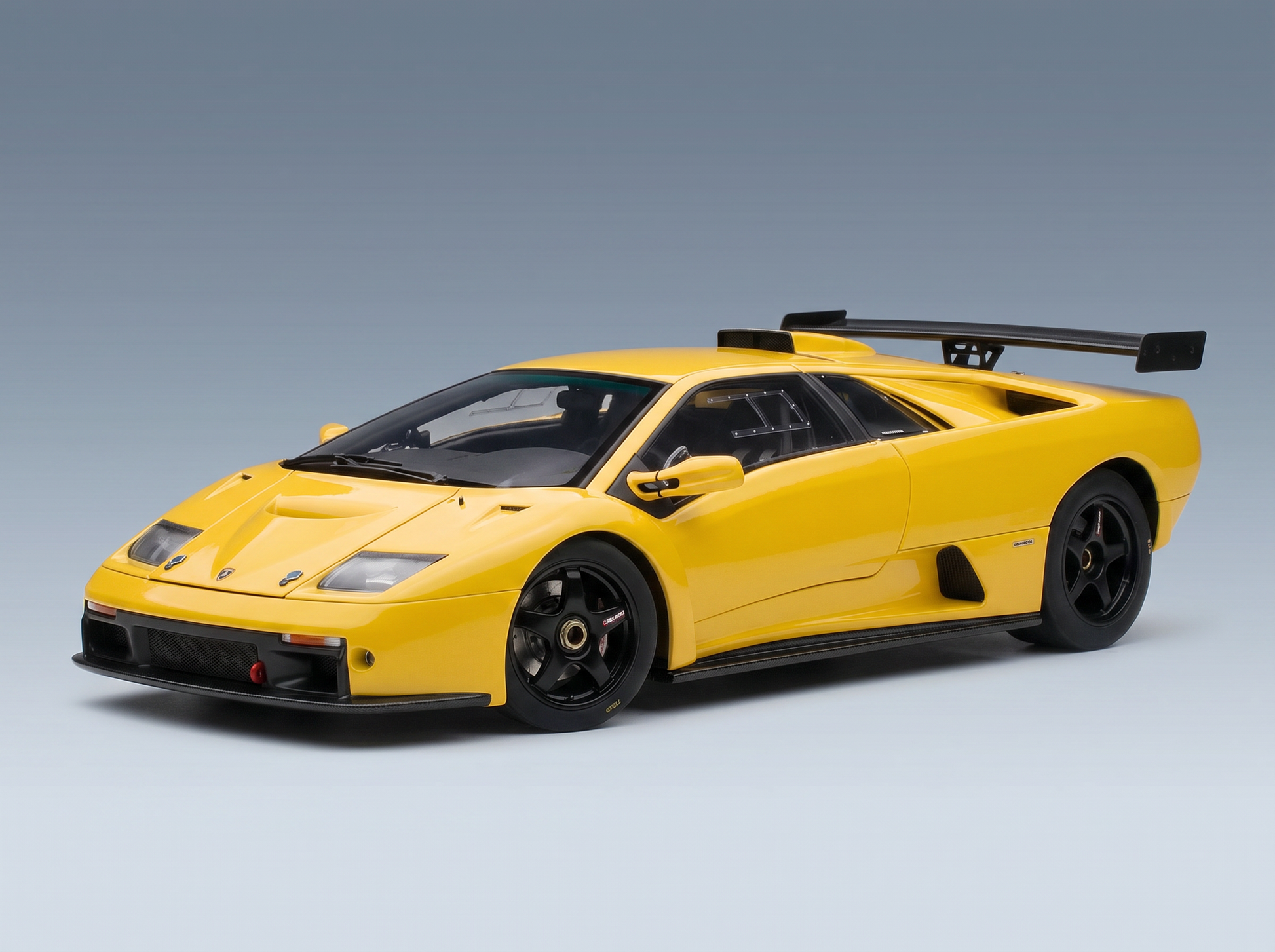 Yellow Lamborghini Diablo GT scale model car with black wings, showcased by Vroomi for collectors.