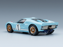 Light blue Ford GT40 scale model car with #1 racing livery, gold wheels, Goodyear tires — Vroomi