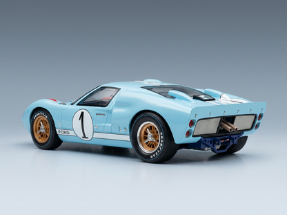 Light blue Ford GT40 scale model car with #1 racing livery, gold wheels, Goodyear tires — Vroomi