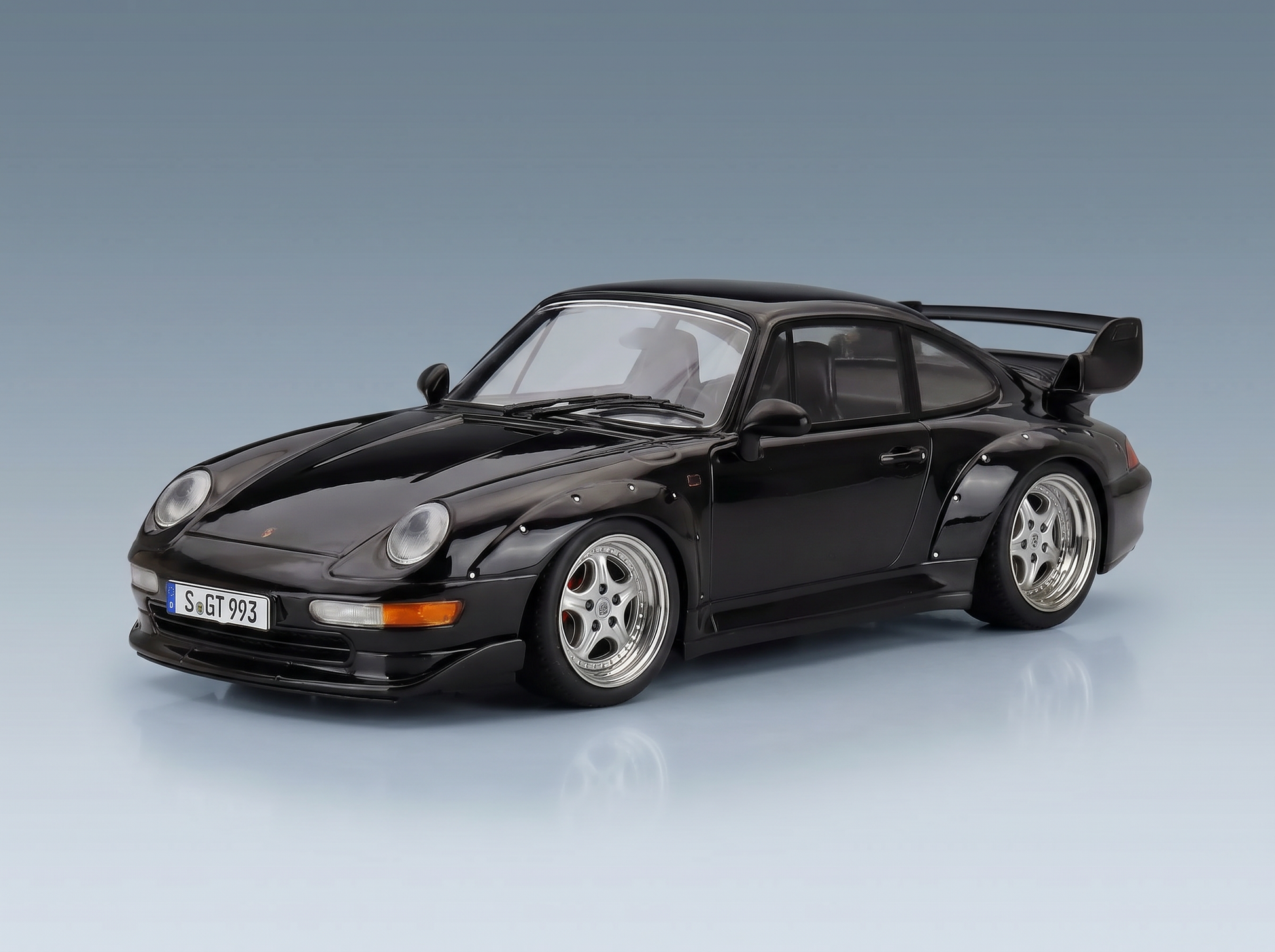 Black Porsche 911 GT2 scale model car with rear wing, showcased by Vroomi for collectors