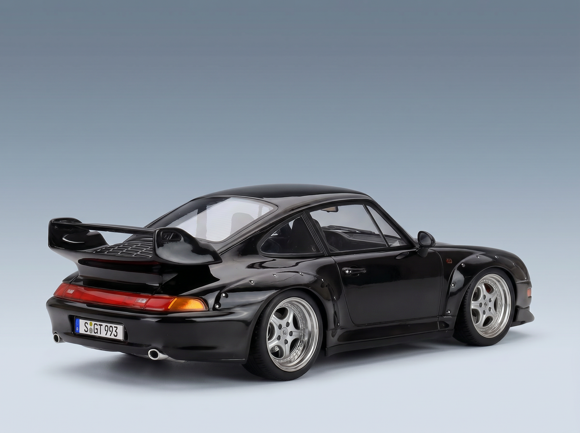 Black Porsche 911 GT2 scale model car with widebody kit, rear wing, and silver rims — Vroomi