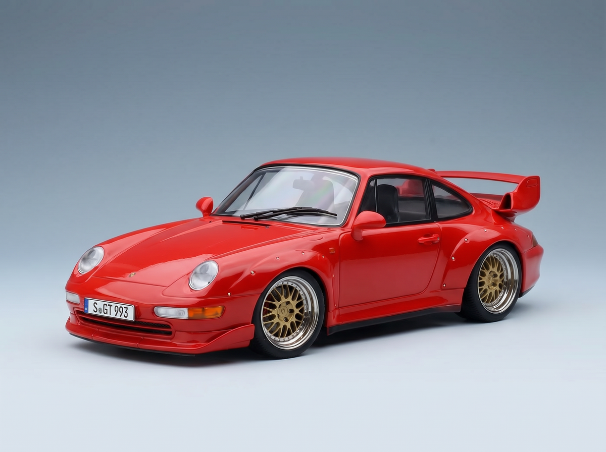 Red Porsche 911 GT2 scale model car with gold wheels, showcased by Vroomi for collectors.