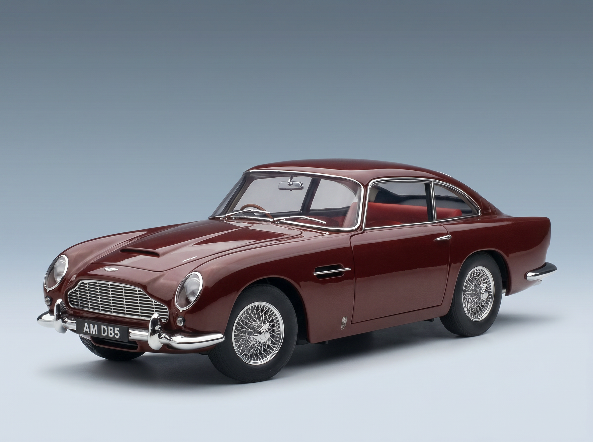 Elegant maroon Aston Martin DB5 scale model car from Vroomi, showcasing classic design and wire wheels.