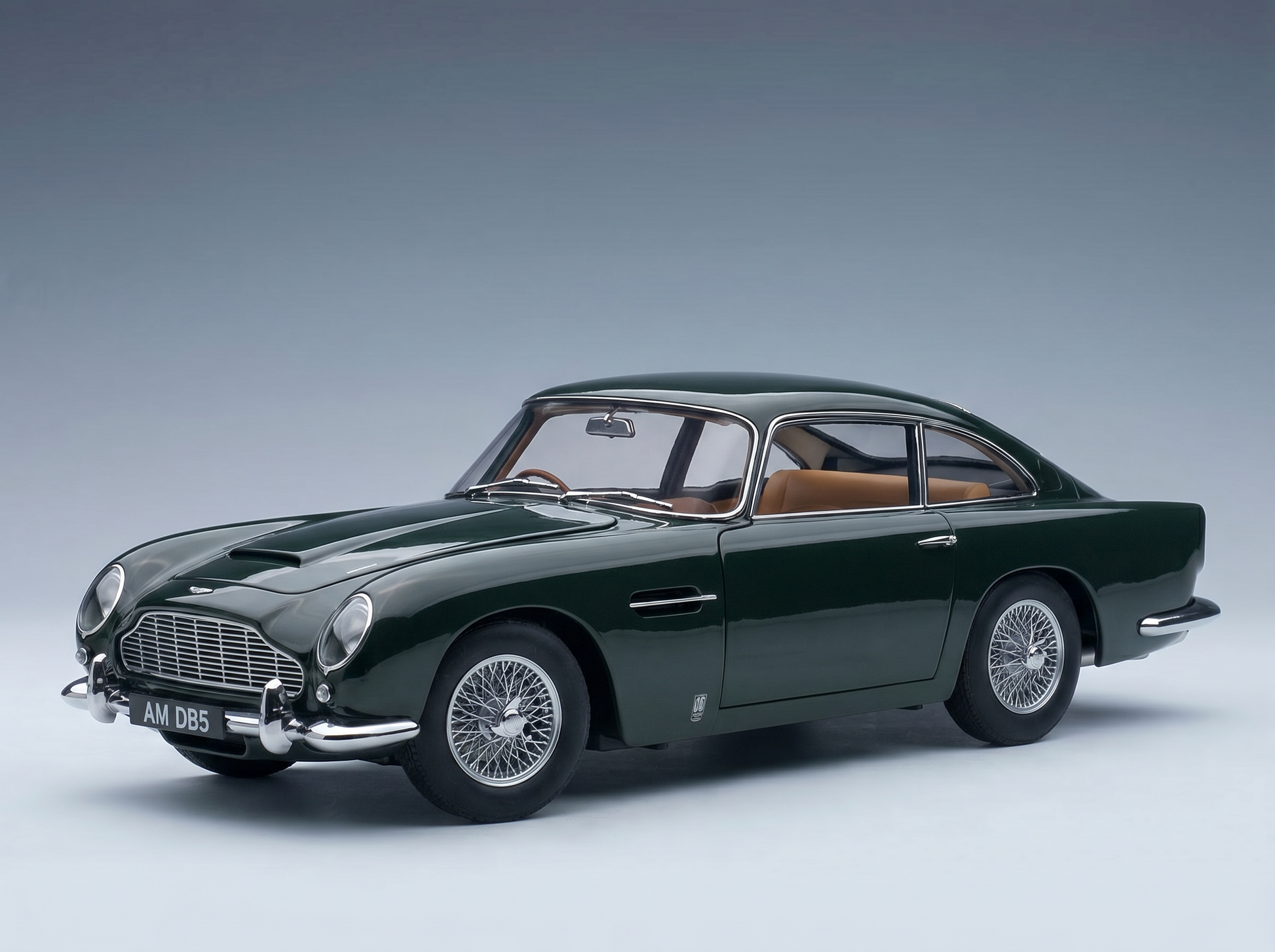 Green Aston Martin DB5 scale model car with wire wheels, showcased by Vroomi for collectors.