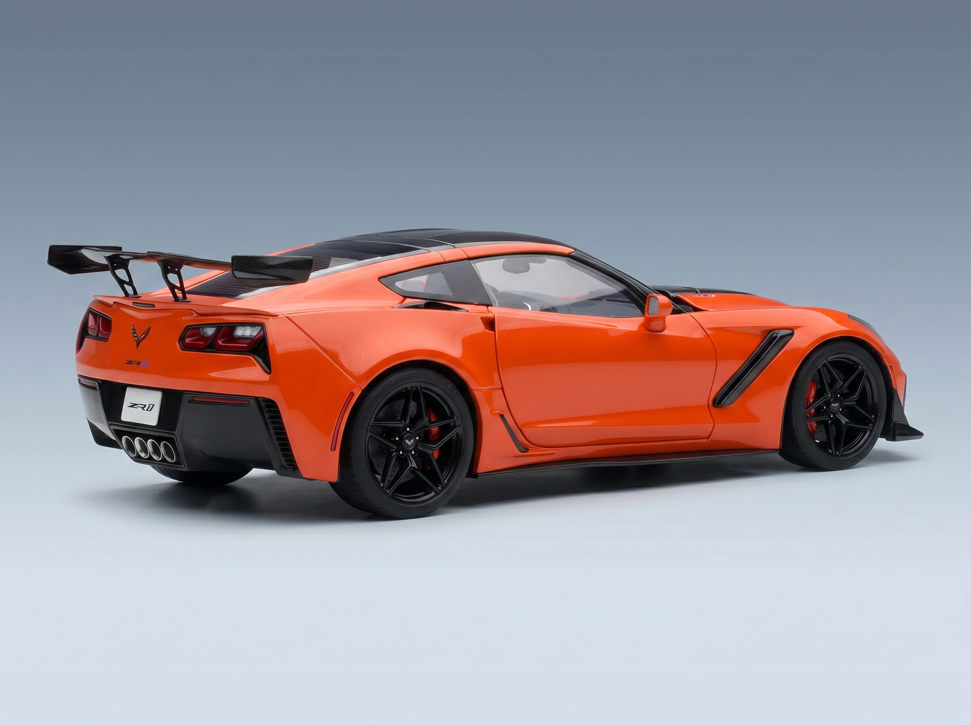 Orange Corvette ZR1 scale model car with black wheels and rear wing, showcased by Vroomi