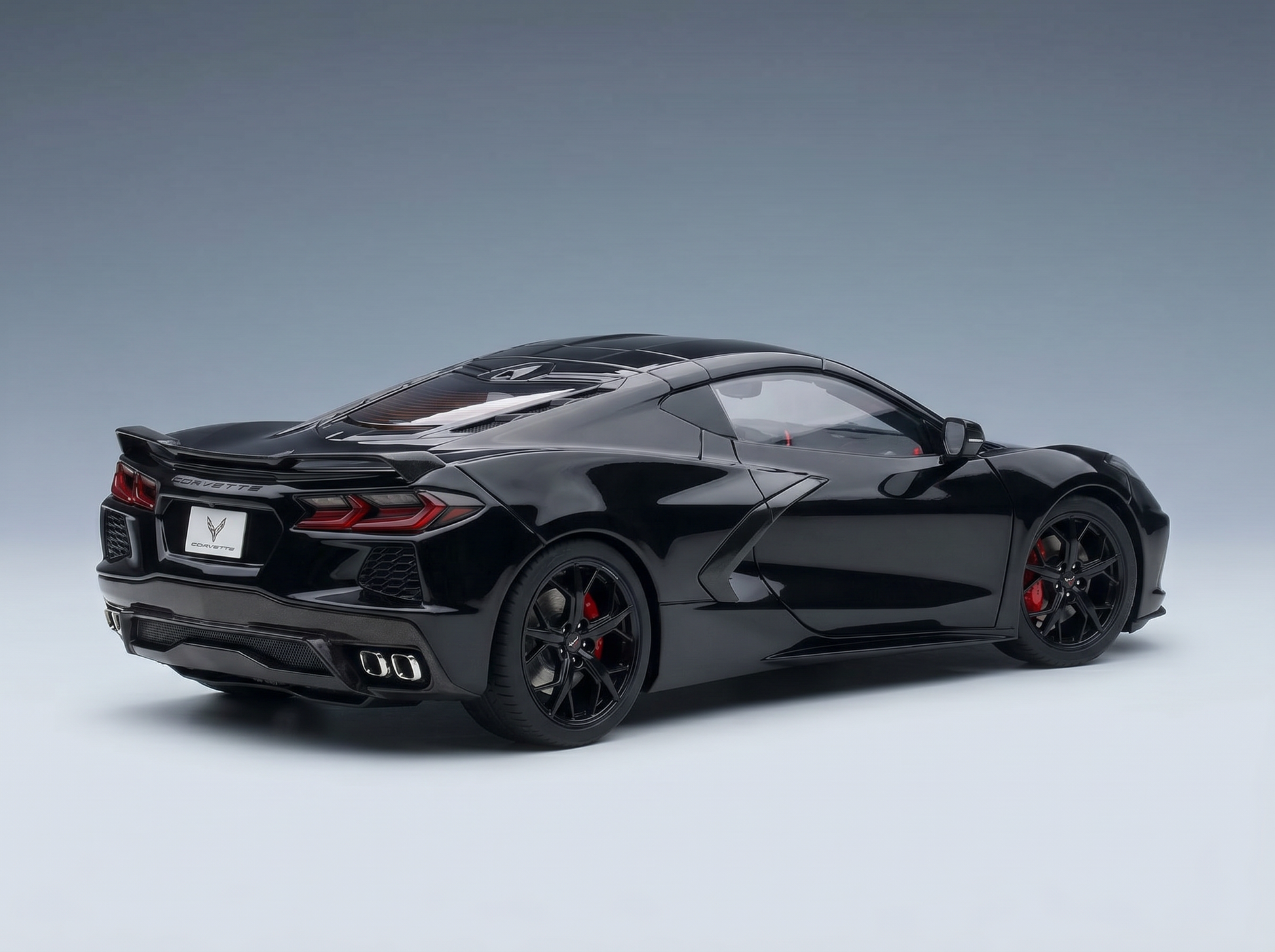 Black Corvette scale model car with red brake calipers, showcased by Vroomi for collectors.