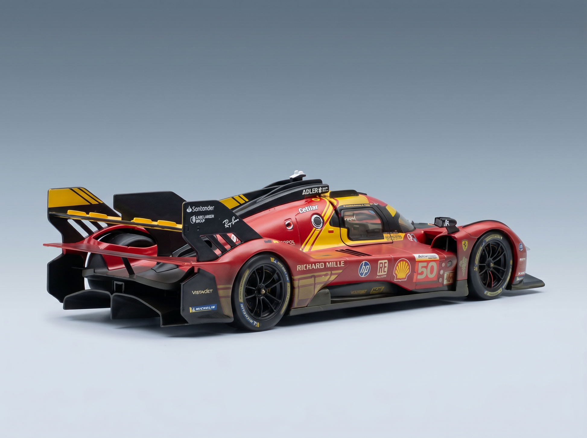Red and yellow scale model car with racing decals, showcased by Vroomi for collectors.