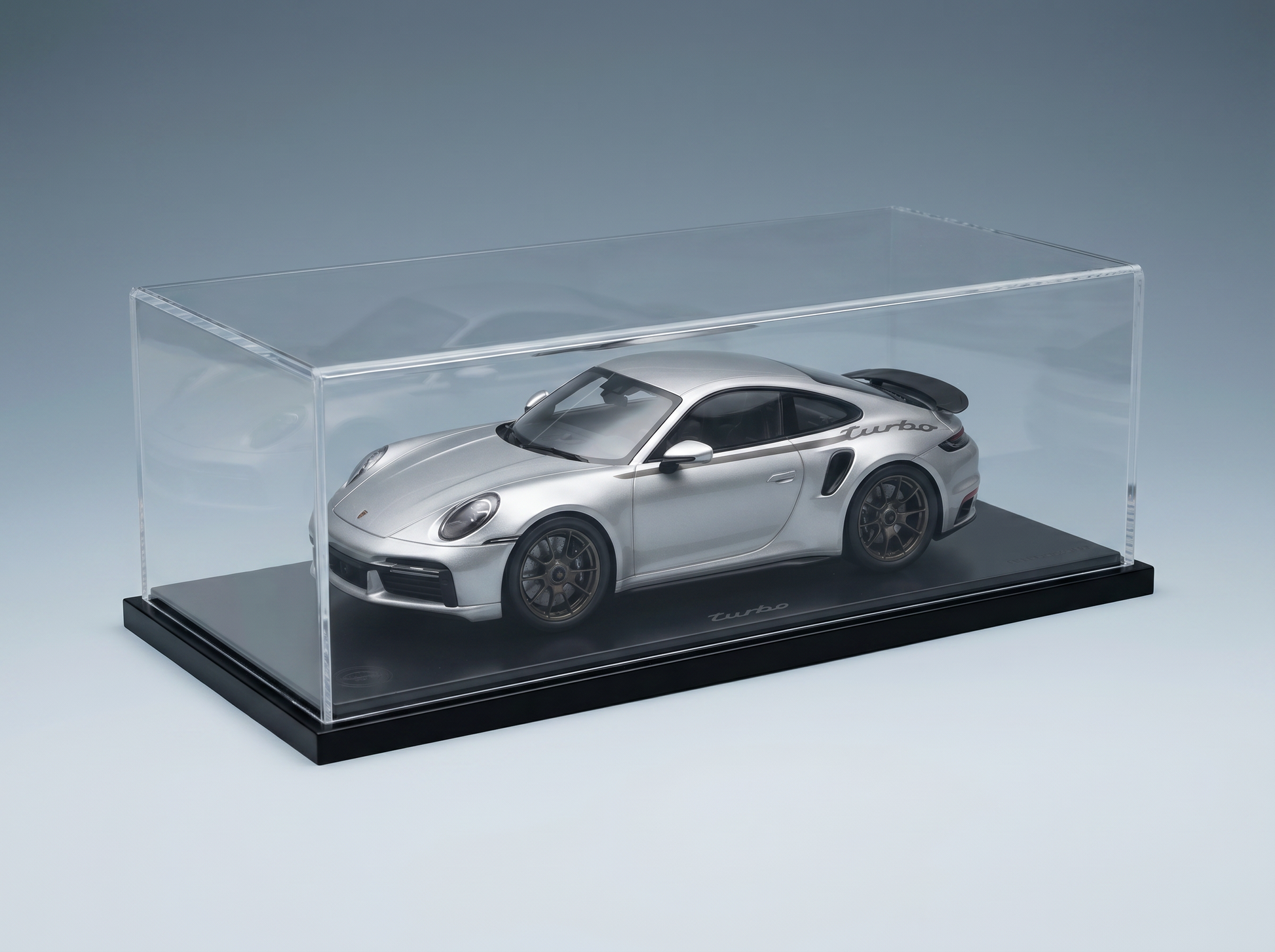 Silver Porsche 911 Turbo scale model car in clear display case, showcased by Vroomi for collectors.