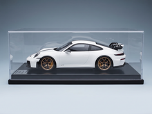 White Porsche 911 GT3 scale model car with gold wheels in display case, Vroomi collection