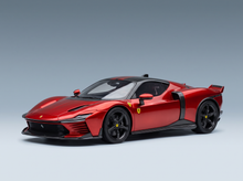 Red ferrari sf90 stradale model car with black accents and yellow prancing horse emblems in roso magma red