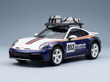 Porsche 953 Roughroads scale model car with roof rack, featured by Vroomi for collectors.