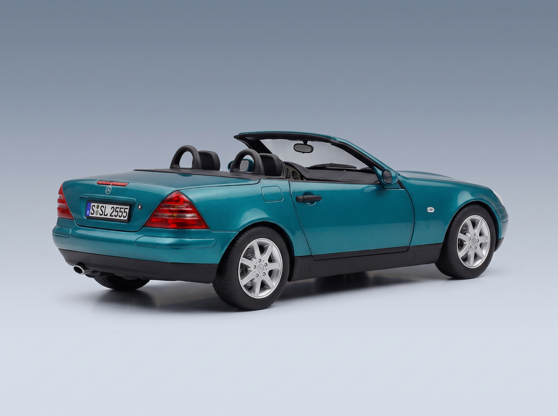Teal Mercedes-Benz SLK scale model car by Vroomi, showcasing convertible top and detailed rear design