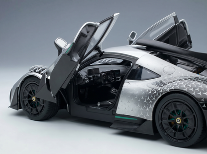 Silver scale model car with open doors, detailed interior, and Vroomi branding for collectors.
