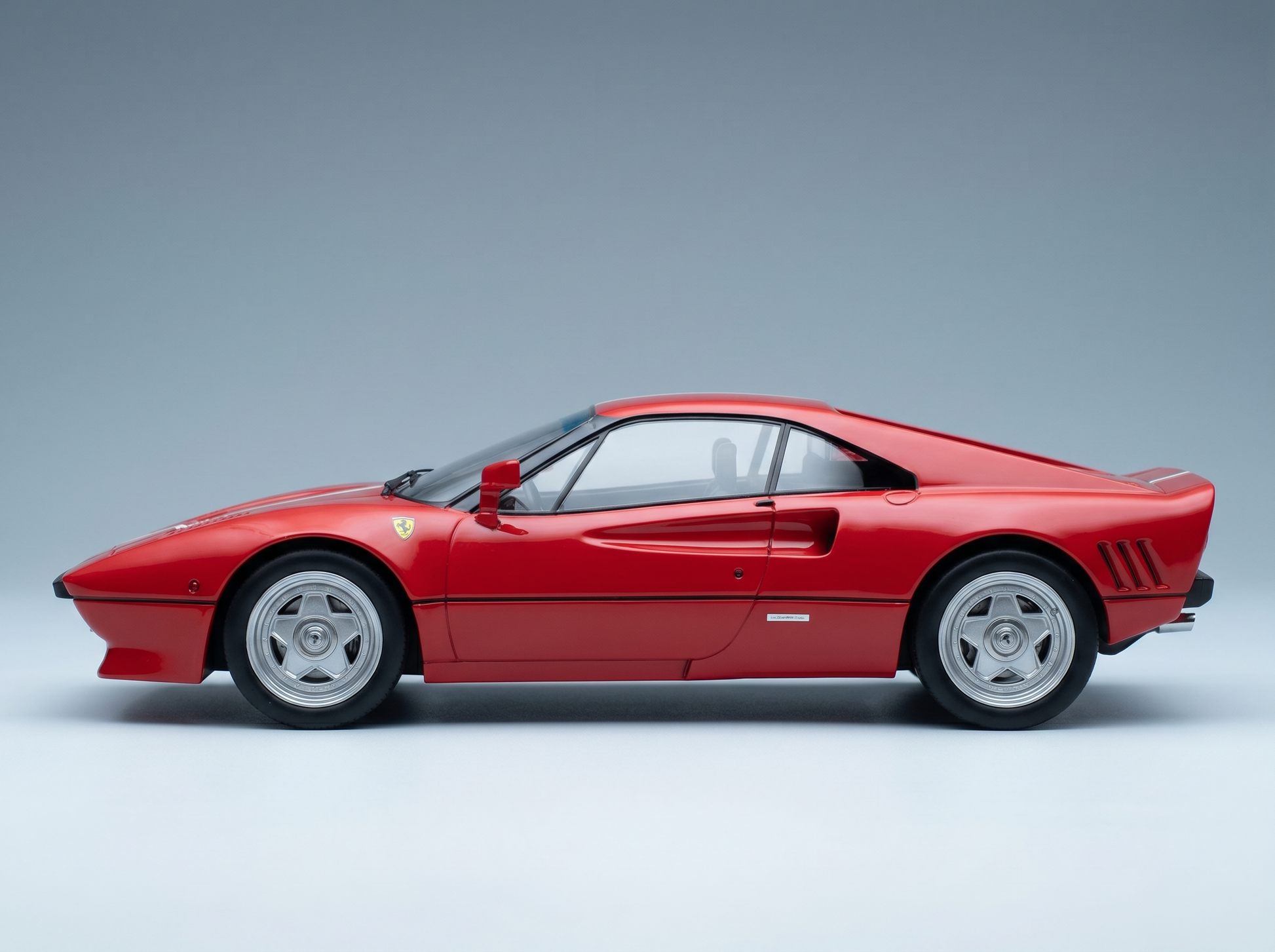 Red Ferrari scale model car showcased at Vroomi for collectors and motorsport fans