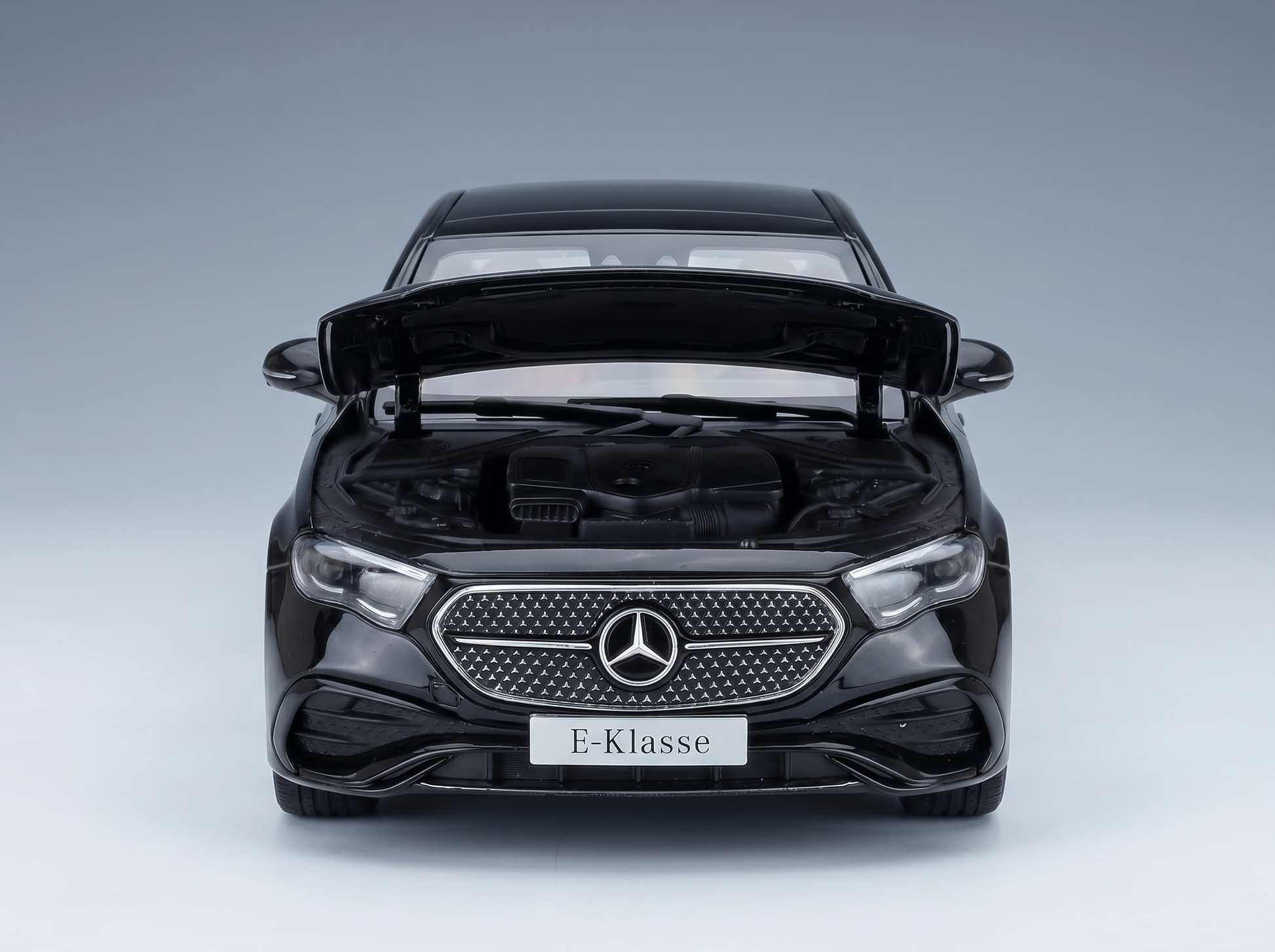 Black Mercedes E-Klasse scale model car with open hood, showcased by Vroomi