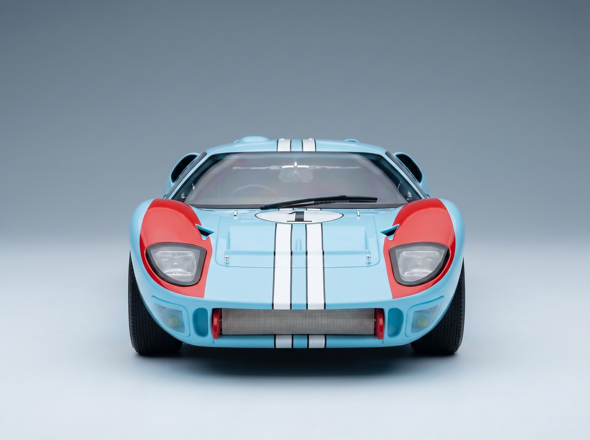 Blue and red scale model car with white stripes, showcased by Vroomi for collectors.