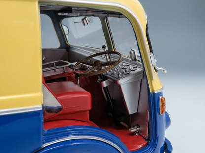 Detailed interior of a blue and yellow scale model car, featuring red seats and dashboard, from Vroomi
