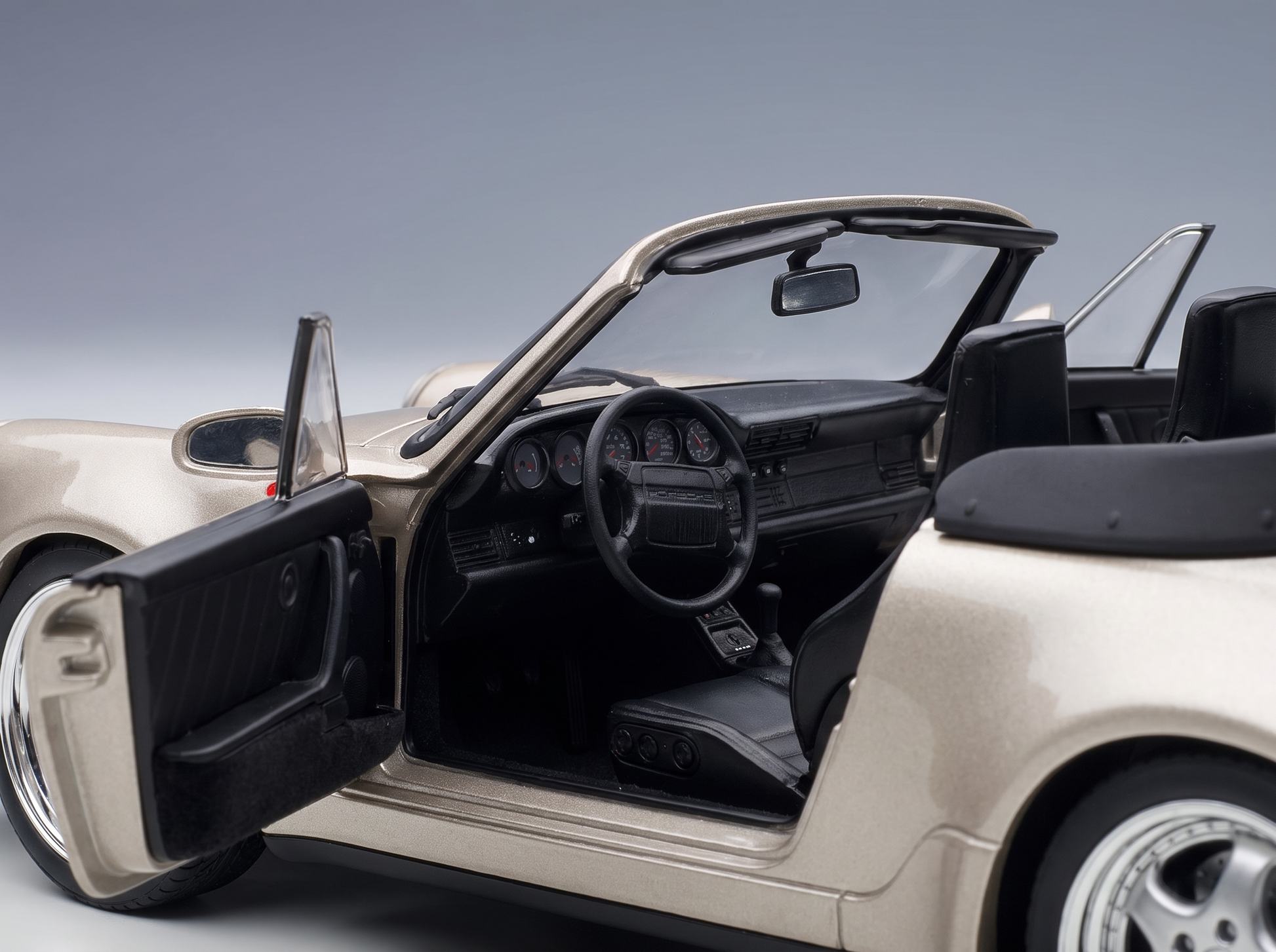 Gold Porsche 911 scale model car with open doors, detailed interior, at Vroomi