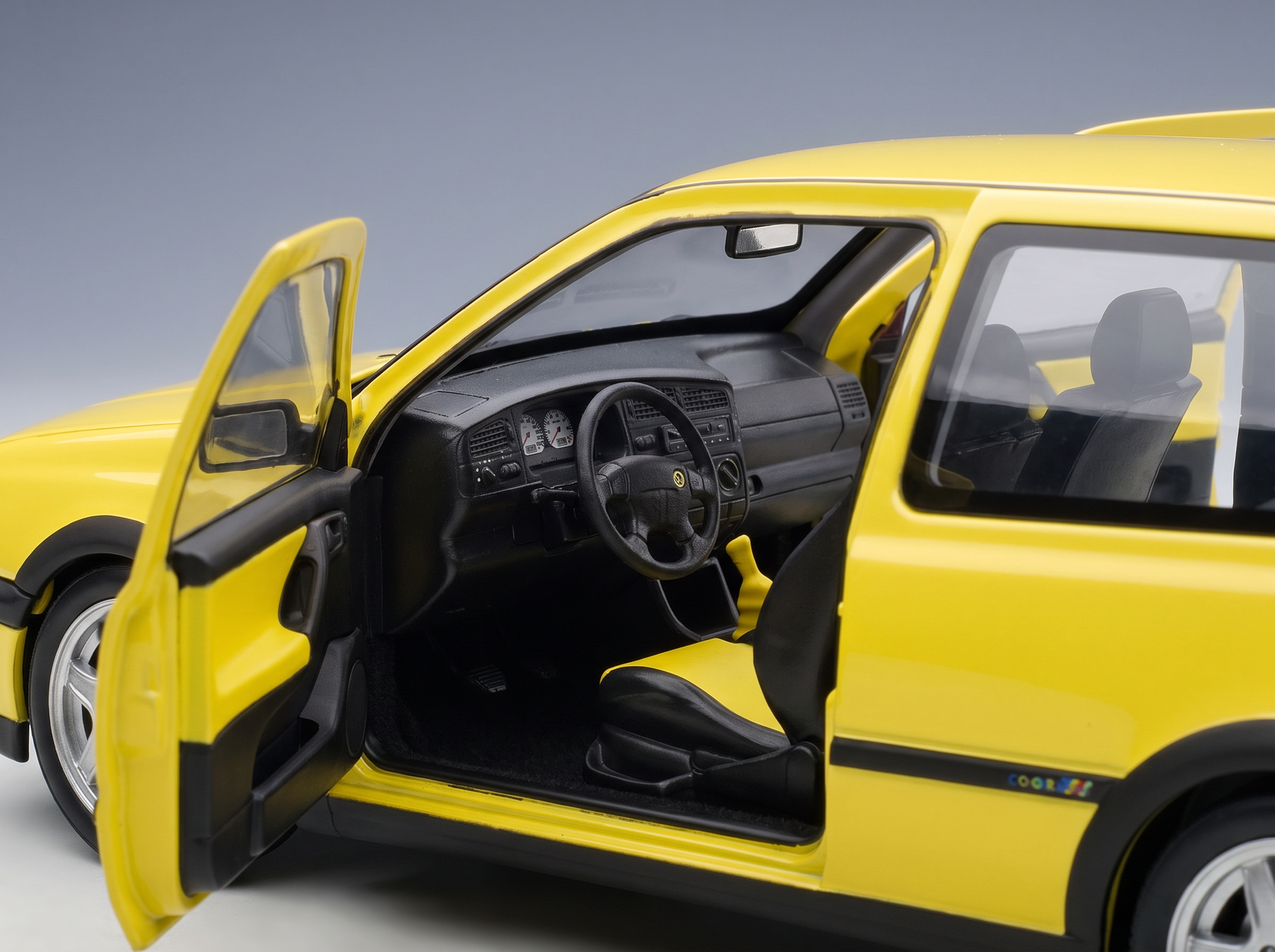 Yellow scale model car with open doors, detailed interior, Vroomi collection