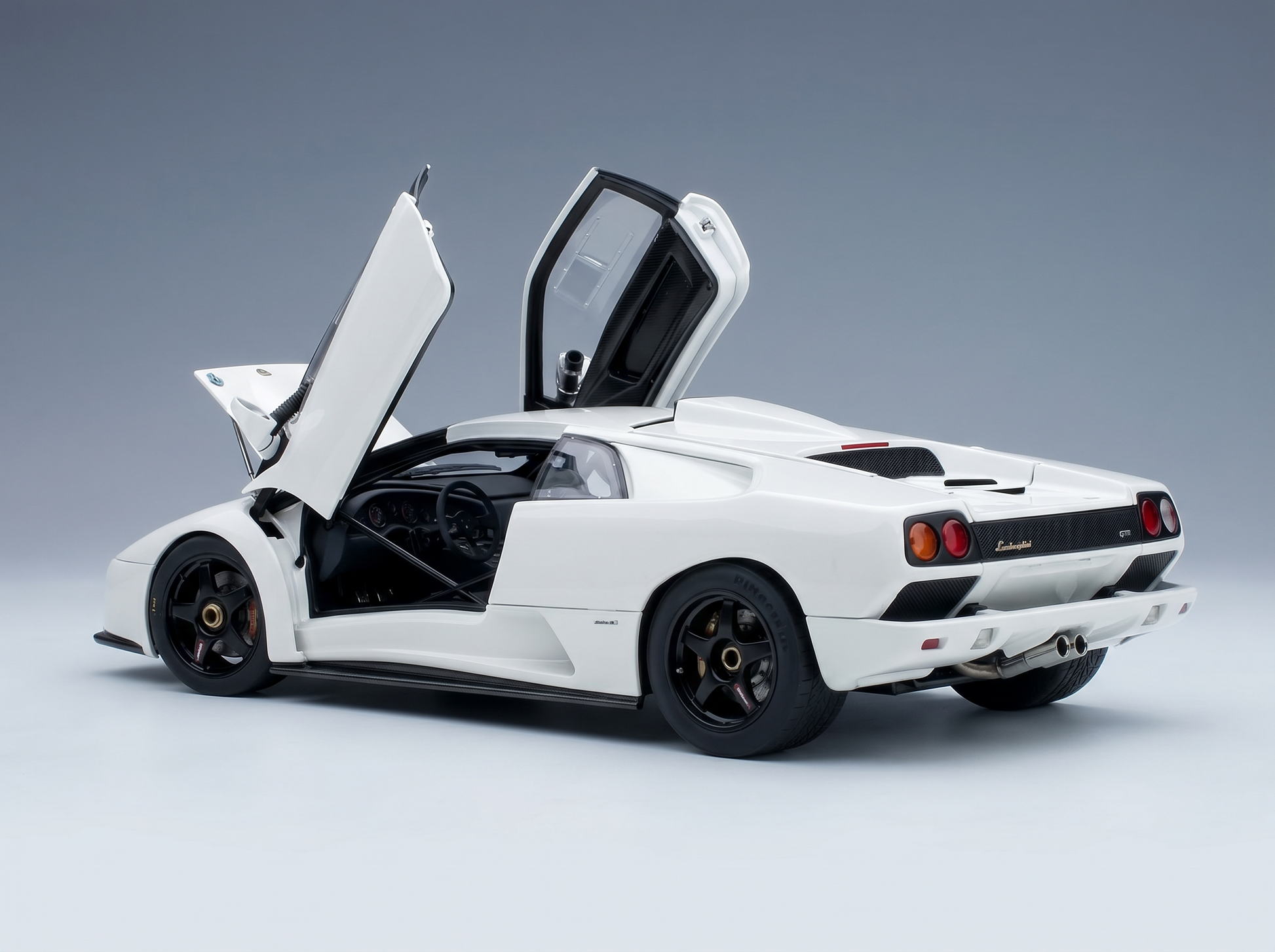 White Lamborghini scale model car with open doors, showcased by Vroomi for collectors.