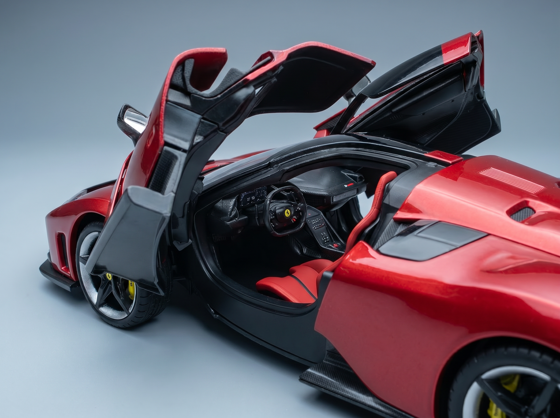 Red Ferrari scale model car with open doors, detailed interior, showcased by Vroomi for collectors
