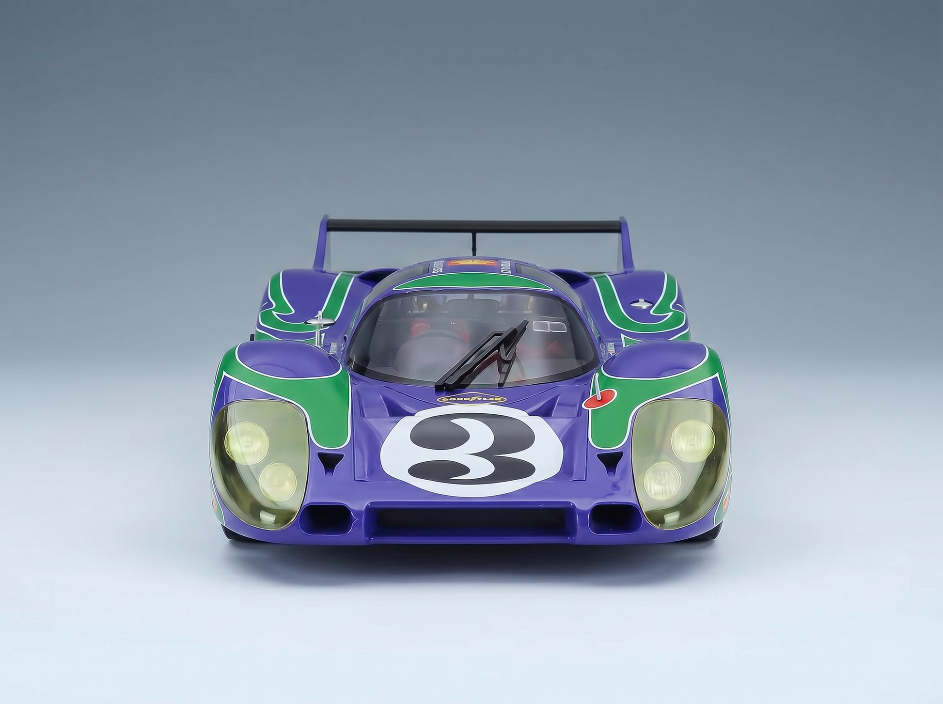 Purple and green scale model car with number 3, showcased by Vroomi for collectors.