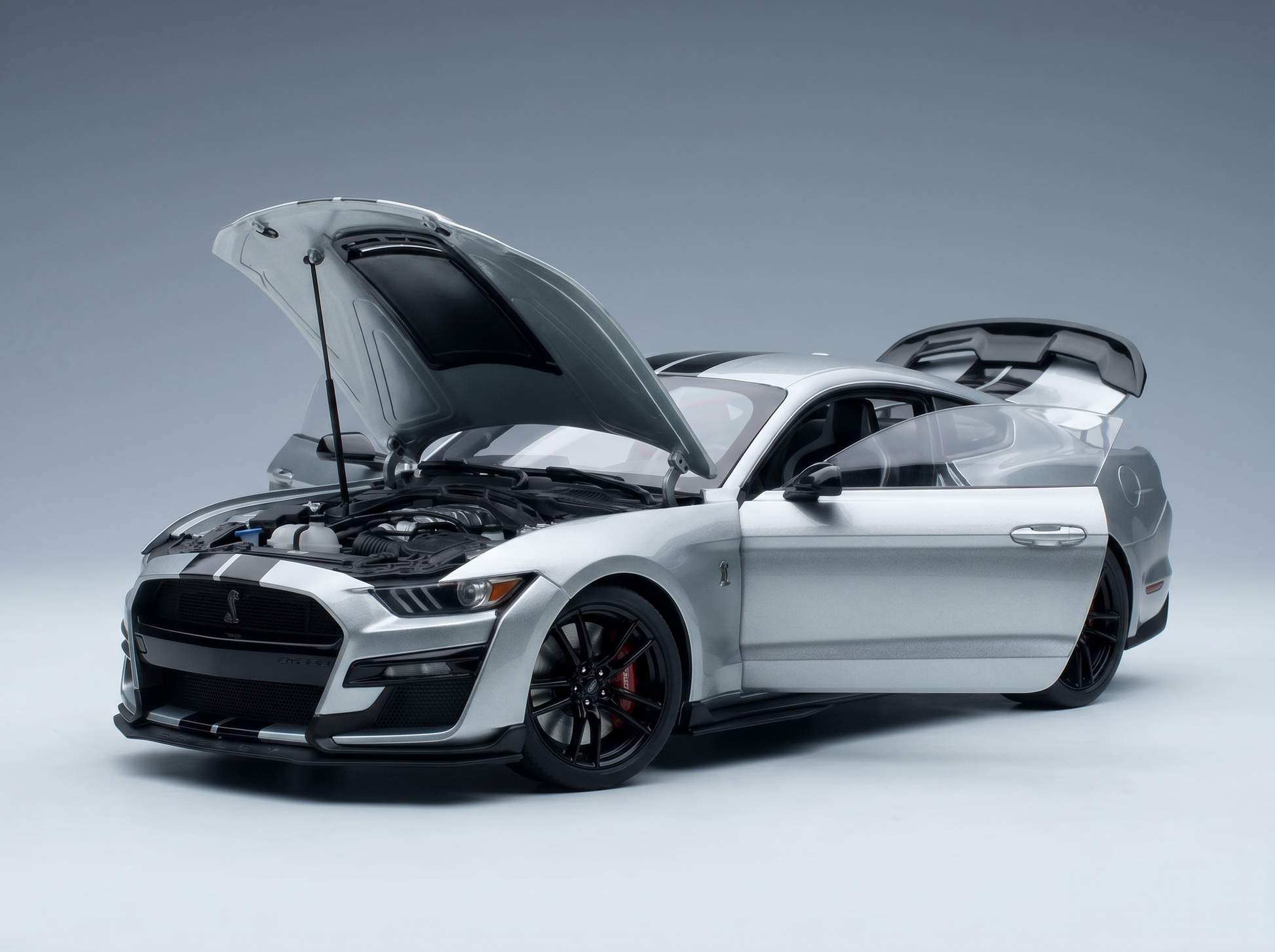 Silver Shelby Mustang scale model car with open hood and trunk, detailed engine, from Vroomi
