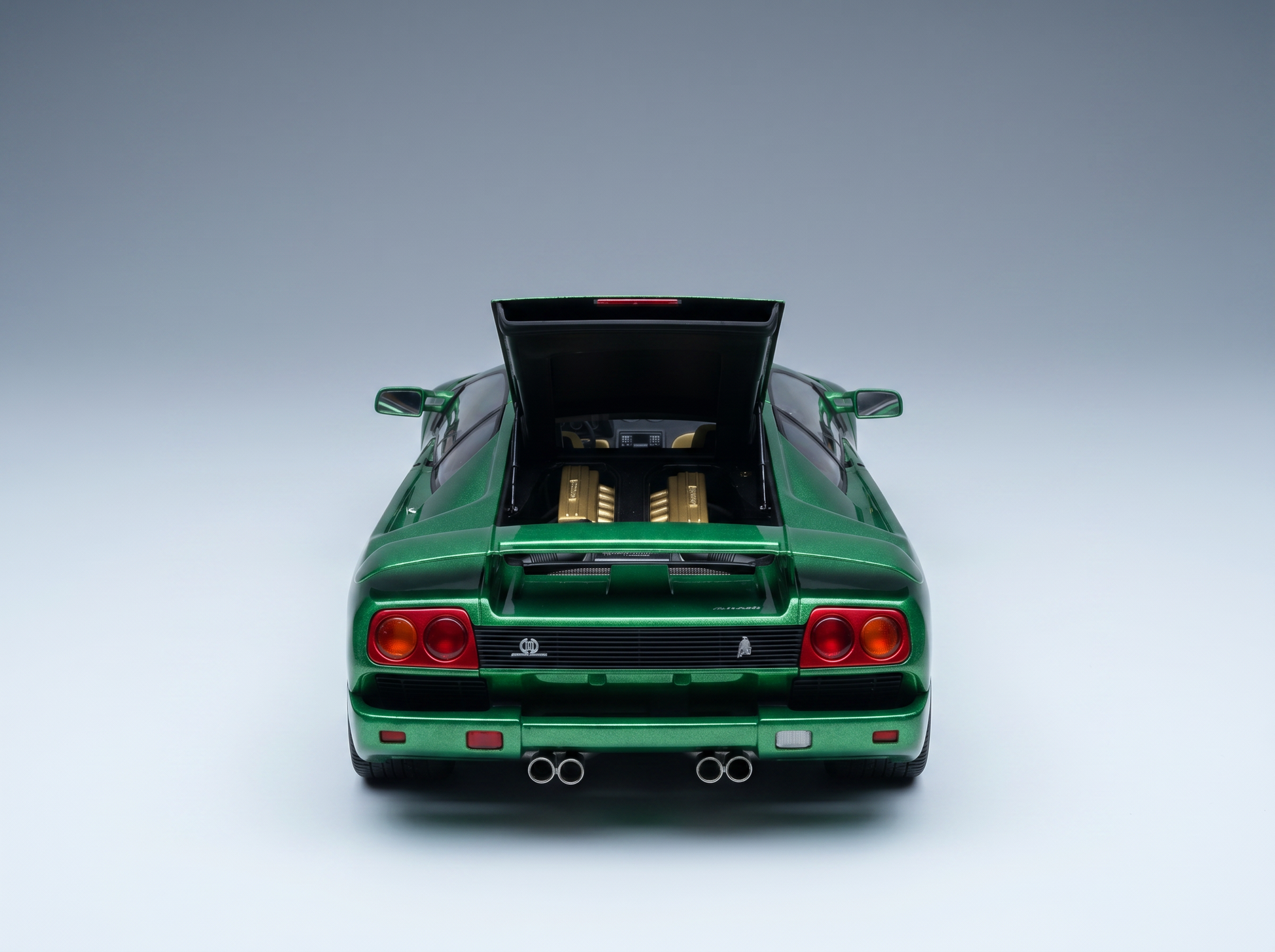 Green scale model car with open rear engine bay, showcased by Vroomi for collectors
