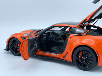 Orange Corvette scale model car with open doors, detailed interior, black wheels — Vroomi