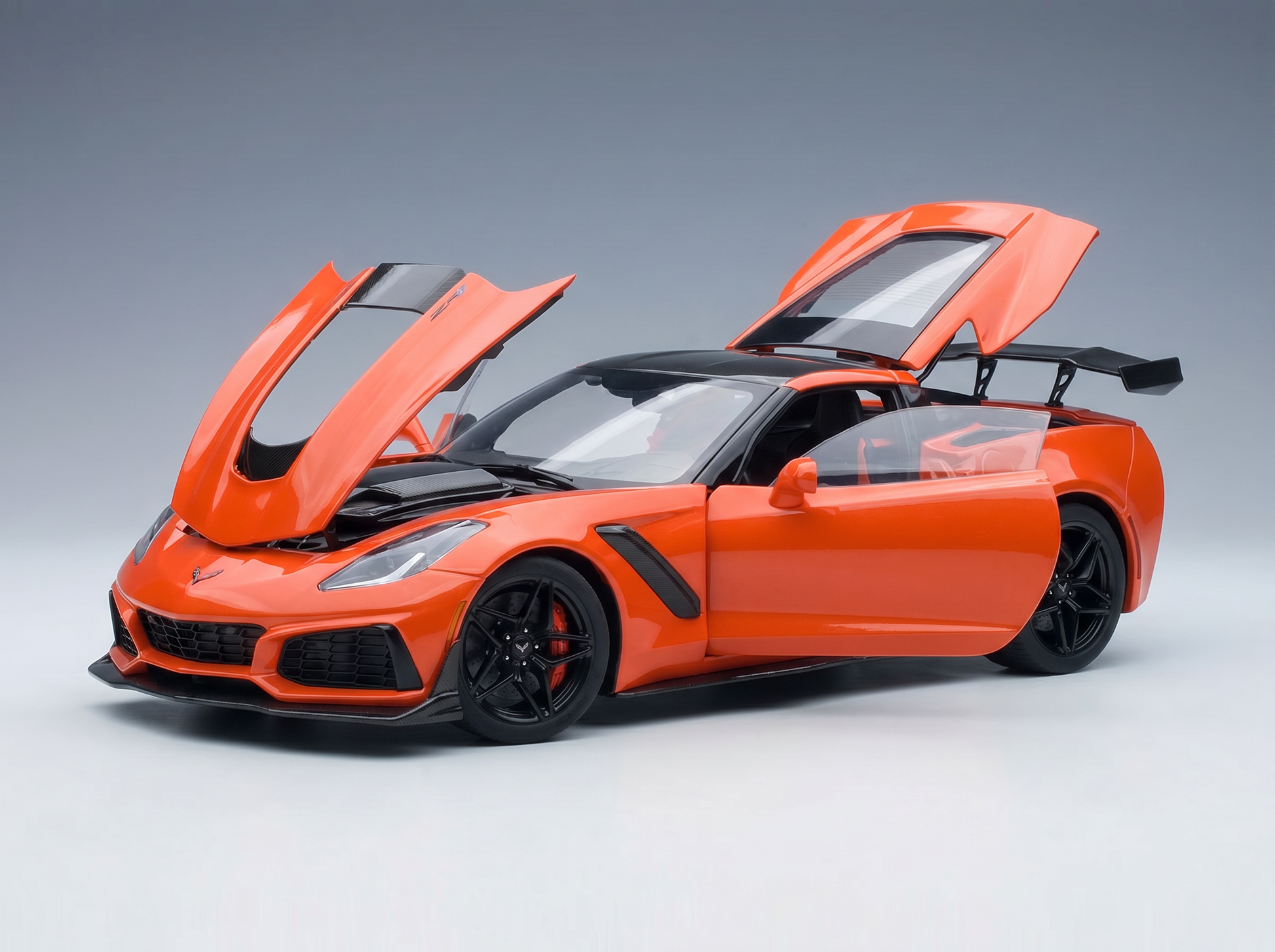 Vroomi orange Corvette scale model car with open doors and hood, detailed die-cast replica