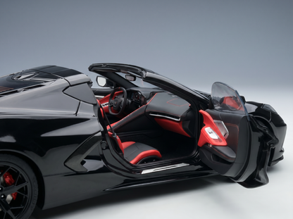 Black scale model car with red interior, doors open, showcased by Vroomi for collectors.